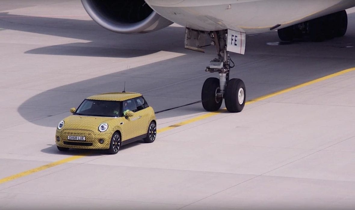 Mini Cooper SE Electric Teased Towing An Aircraft