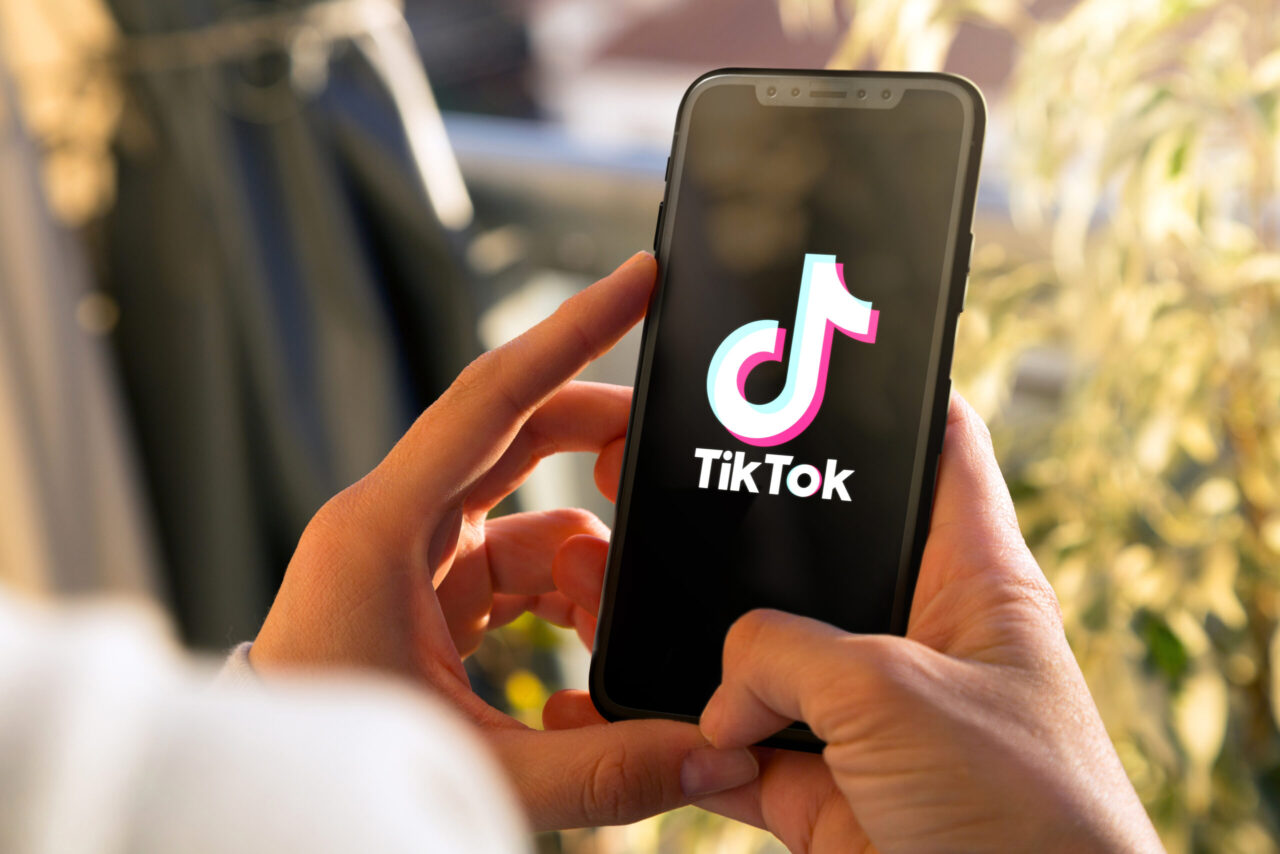 Tiktok on mobile phone Screen. Young woman holding a Smart Phone with Tik Tok app. ROSARIO, ARGENTINA MARCH 15, 2023.